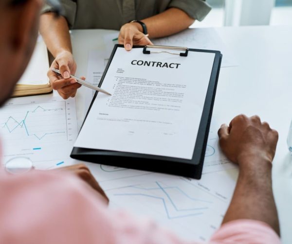 Closeup shot of two businesspeople going through paperwork in an office Closeup shot of two businesspeople going through paperwork in an office